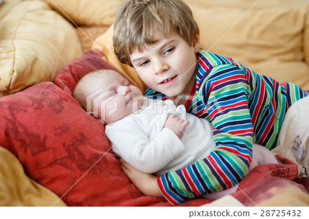 Happy little kid boy with newborn baby sister girl Happy little kid boy with newborn baby sister girl 28725432