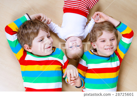 Two happy little preschool kids boys with newborn 28725601