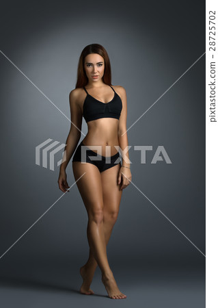 Pretty fitness trainer in black top and short 28725702
