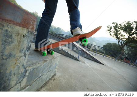 skateboarder legs riding skateboard at skatepark 28729139