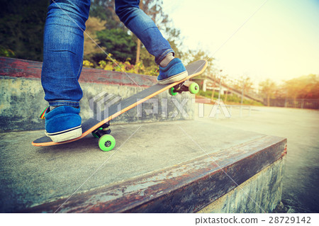 skateboarder legs riding skateboard at skatepark 28729142
