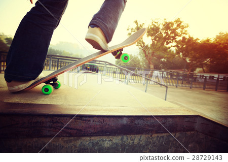 skateboarder legs riding skateboard at skatepark 28729143