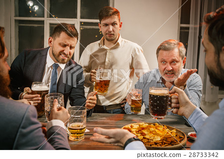 Group of friends enjoying evening drinks with beer 28733342