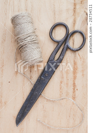 Old scissors and skein jute twine. 28734511