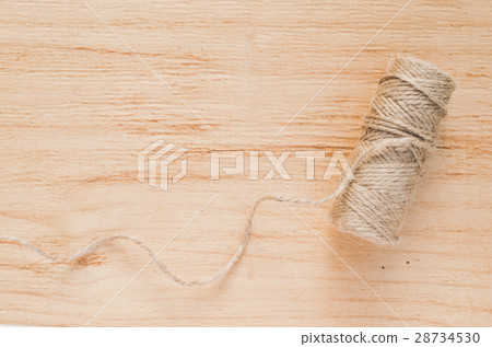 Skein jute twine on a wooden background. 28734530
