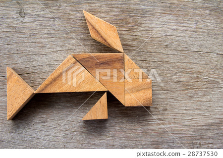 Wooden tangram puzzle in fish shape background 28737530
