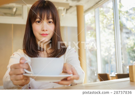 A young Japanese woman working in a cafe A young Japanese woman working in a cafe 28737836