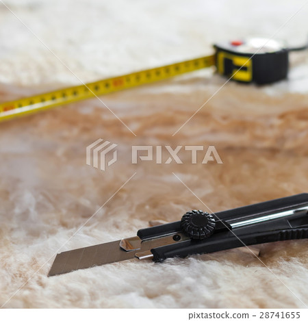 Measure tape and knife on mineral wool 28741655
