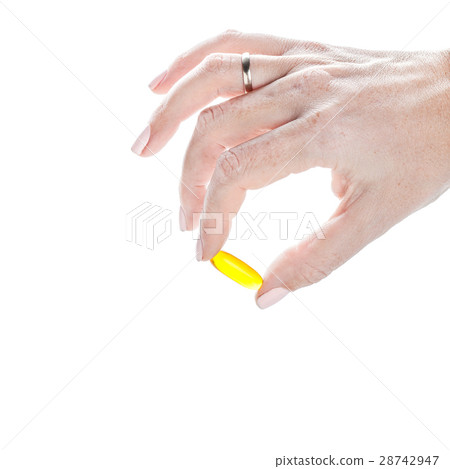 Soft gels pills with Omega-3 oil in fingers 28742947