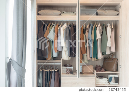 colorful clothes hanging on rail 28743435