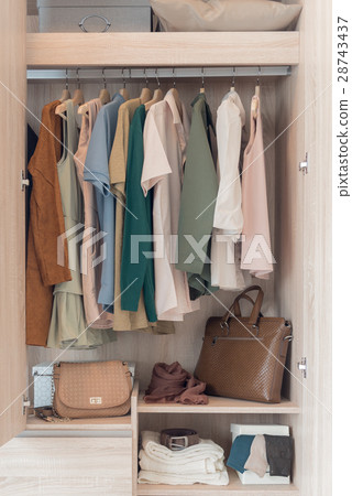 colorful clothes hanging on rail 28743437