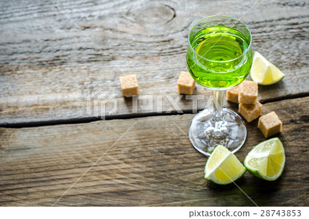 Glass of absinthe with lime and sugar cubes 28743853