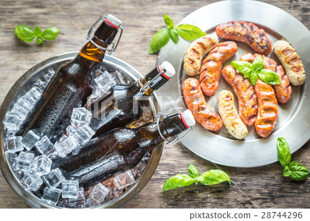 Grilled sausages with bottles of beer Grilled sausages with bottles of beer 28744296