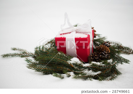 christmas gift and fir wreath with cones on snow christmas gift and fir wreath with cones on snow 28749661