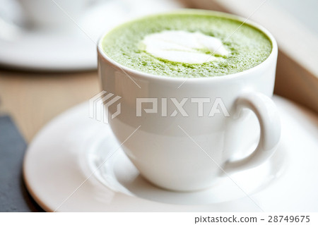 white cup of matcha green tea latte on table 28749675