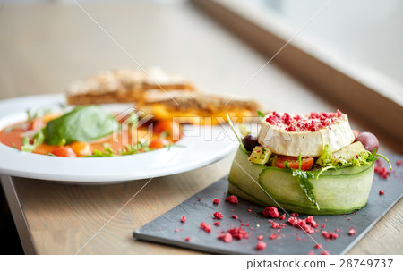 goat cheese salad and gazpacho soup at restaurant goat cheese salad and gazpacho soup at restaurant 28749737