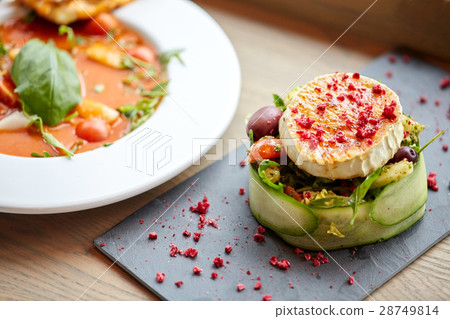 goat cheese salad and gazpacho soup at restaurant goat cheese salad and gazpacho soup at restaurant 28749814