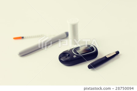close up of glucometer, insulin pen and syringe close up of glucometer, insulin pen and syringe 28750094