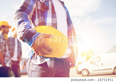 close up of builder holding hardhat at building 28751951