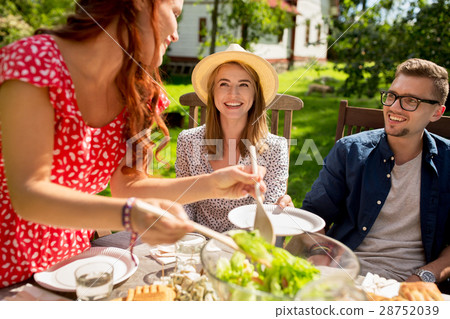 happy friends having dinner at summer garden party 28752039