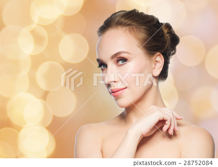 beautiful young woman face over holidays lights beautiful young woman face over holidays lights 28752084