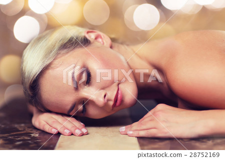 young woman lying on hammam table in turkish bath 28752169