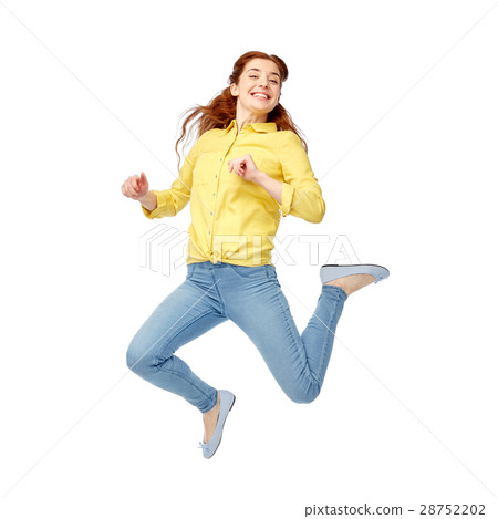 smiling young woman jumping in air smiling young woman jumping in air 28752202