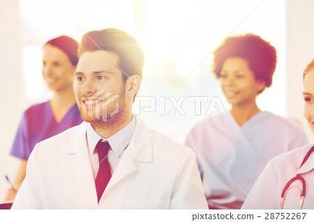 happy doctor over group of medics at hospital happy doctor over group of medics at hospital 28752267