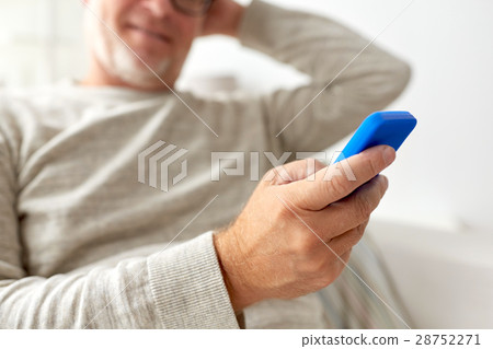 close up of old man texting on smartphone at home close up of old man texting on smartphone at home 28752271