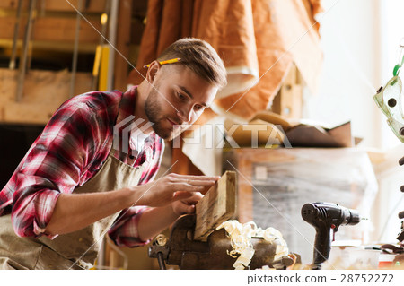 carpenter working with wood plank at workshop carpenter working with wood plank at workshop 28752272