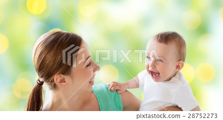 happy mother with little baby over green lights happy mother with little baby over green lights 28752273