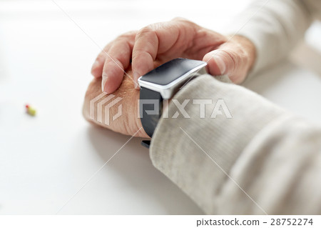 close up of old man hand with pill and smart watch close up of old man hand with pill and smart watch 28752274