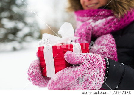 close up of woman with christmas gift outdoors close up of woman with christmas gift outdoors 28752378