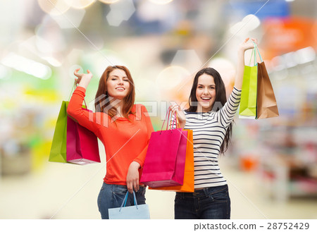 teenage girls with shopping bags and credit card 28752429