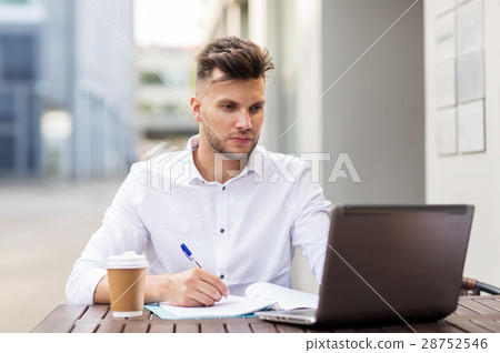 man with laptop and coffee at city cafe 28752546