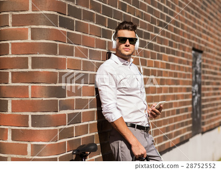 man with headphones, smartphone and bicycle 28752552
