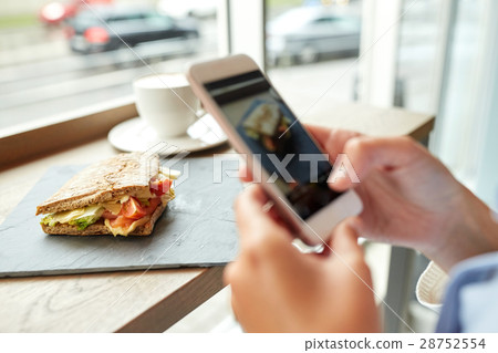 hands with smartphone photographing food hands with smartphone photographing food 28752554