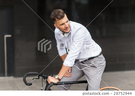 man with bicycle and headphones on city street man with bicycle and headphones on city street 28752944