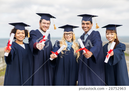 happy students in mortar boards with diplomas 28752963