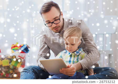 father and son with tablet pc playing at home father and son with tablet pc playing at home 28753212