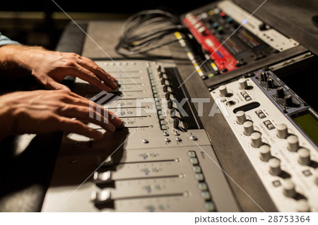man using mixing console in music recording studio 28753364