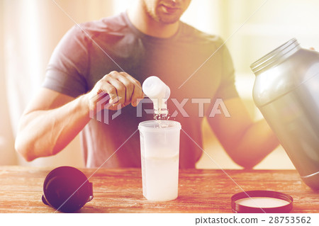 close up of man with protein shake bottle and jar 28753562