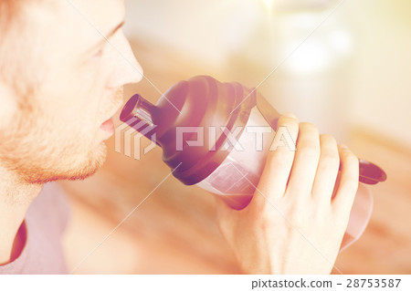 close up of man drinking protein shake 28753587