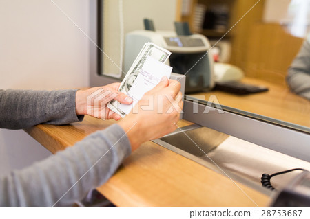 customer with money and receipt at bank counter customer with money and receipt at bank counter 28753687