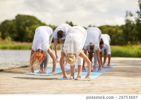 group of people making yoga exercises outdoors 28753697