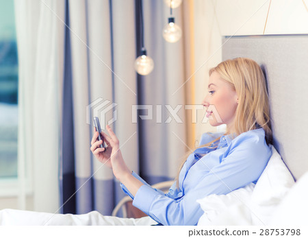 happy businesswoman with smartphone in hotel room happy businesswoman with smartphone in hotel room 28753798
