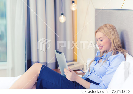 happy businesswoman with tablet pc in hotel room happy businesswoman with tablet pc in hotel room 28753800