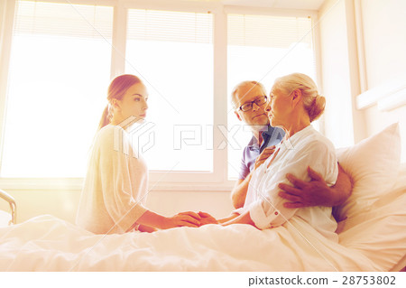 family visiting ill senior woman at hospital 28753802