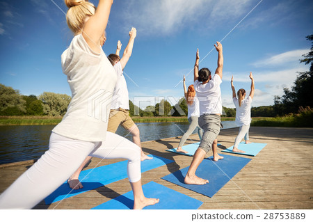 group of people making yoga exercises outdoors 28753889