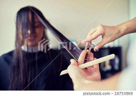 happy woman with stylist cutting hair at salon happy woman with stylist cutting hair at salon 28753969